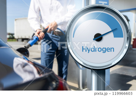 Man holds a hydrogen fueling nozzle on a hydrogen filling station. Refueling car with hydrogen fuel Man holds a hydrogen fueling nozzle on a hydrogen filling station. Refueling car with hydrogen fuel 119966603