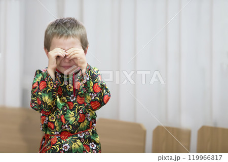 The little boy is crying.Kid covered his face with his hands The little boy is crying.Kid covered his face with his hands 119966817