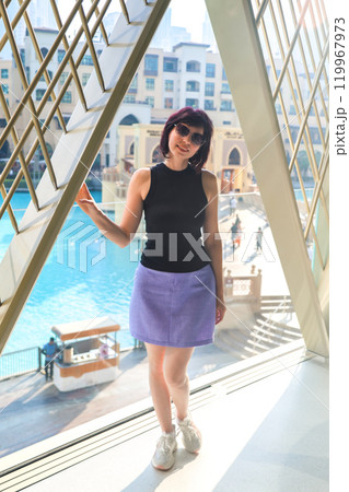 Portrait of a woman with an athletic build in a summer blouse and short skirt 119967973