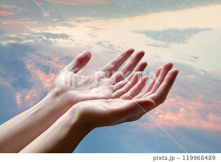 The outstretched hands of a praying man 119968489