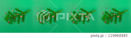 A few Tree branches with cones and mountain ash. New Year and Christmas content green background long banner ornament pattern photo 119968985
