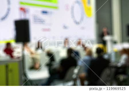 Speaker giving talk in conference hall at business event. Rear view of unrecognizable people in audience at the conference hall. Speaker giving talk in conference hall at business event. Rear view of unrecognizable people in audience at the conference hall. 119969525