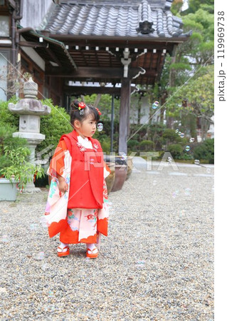 七五三詣で可愛い三歳の女の子、神社仏閣での和装ロケーション撮影、被布キッズフォト家族写真 119969738
