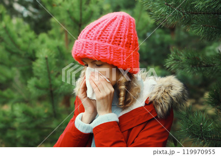 Sick exhausted woman sneezing blow nose using tissue, unhealthy suffering girl feels unwell outdoors Sick exhausted woman sneezing blow nose using tissue, unhealthy suffering girl feels unwell outdoors 119970955