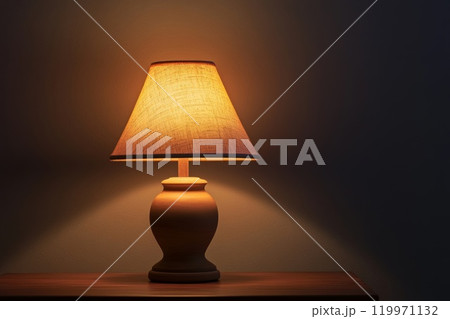 Lighted lamp set against a dark background. 119971132