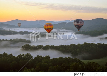 Air balloons floating above the foggy mountains. 119971139
