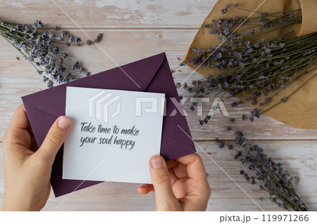 TAKE TIME TO MAKE YOUR SOUL HAPPY text on supportive message paper note reminder from green envelope. Flat lay composition dry lavender flowers. Concept of inner happiness, slowing-down digital detox 119971266