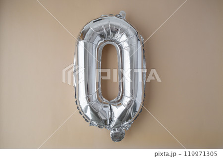 0 ZERO metallic balloon on beige neutral background. Greeting card silver foil balloon number Happy birthday holiday concept. Copy space for text. Celebration party congratulation 0 ZERO metallic balloon on beige neutral background. Greeting card silver foil balloon number Happy birthday holiday concept. Copy space for text. Celebration party congratulation 119971305