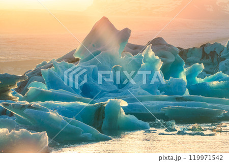 Sunset over blue iceberg with in Jokulsarlon glacier lagoon Sunset over blue iceberg with in Jokulsarlon glacier lagoon 119971542