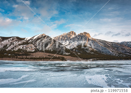 Rocky mountains on frozen lake in Abraham Lake Rocky mountains on frozen lake in Abraham Lake 119971558