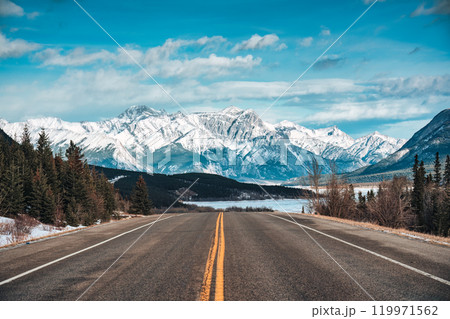 Road trip with on highway road with snow covered rocky mountains in winter at Kootenay plains area, Canada Road trip with on highway road with snow covered rocky mountains in winter at Kootenay plains area, Canada 119971562