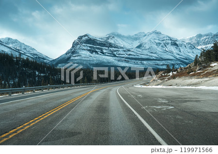 Road trip with on highway road with snow covered rocky mountains in winter at Kootenay plains area, Canada Road trip with on highway road with snow covered rocky mountains in winter at Kootenay plains area, Canada 119971566
