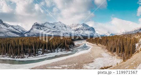 Landscape of rocky mountains and frozen fiver in pine forest at Kootenay plains area, Canada 119971567