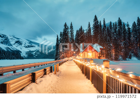 Emerald Lake with wooden lodge glowing in snowy pine forest on winter at Yoho national park, Canada 119971572