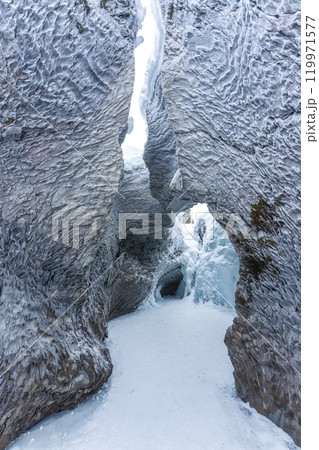 Ice cave with rock formation of water eroded on winter 119971577