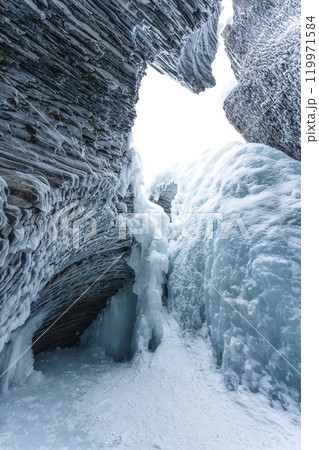 Ice cave with rock formation of water eroded on winter 119971584