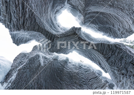 Ice cave with rock formation of water eroded on winter Ice cave with rock formation of water eroded on winter 119971587