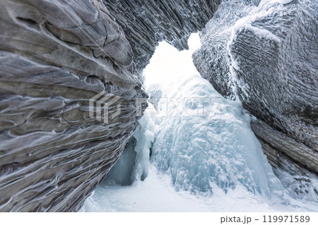 Ice cave with rock formation of water eroded on winter Ice cave with rock formation of water eroded on winter 119971589