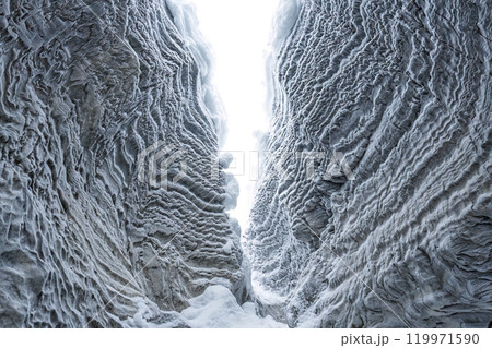 Ice cave with rock formation of water eroded on winter at Natural bridge, Yoho national park, Canada 119971590