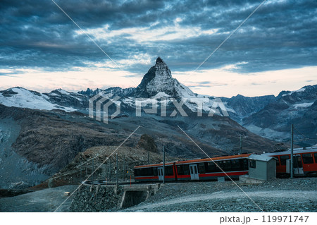 Electric train running on railway through Matterhorn mountain at Gornergrat station Electric train running on railway through Matterhorn mountain at Gornergrat station 119971747
