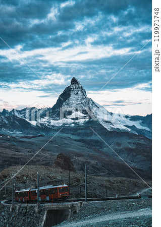 Electric train running on railway through Matterhorn mountain at Gornergrat station 119971748