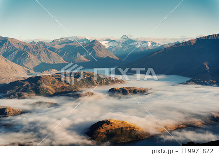 Scenic foggy mountain from summit of Roys Peak with Lake Wanaka in the morning at New Zealand 119971822