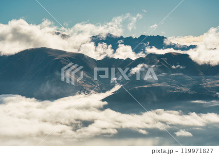Scenic foggy mountain from summit of Roys Peak with Lake Wanaka in the morning at New Zealand Scenic foggy mountain from summit of Roys Peak with Lake Wanaka in the morning at New Zealand 119971827
