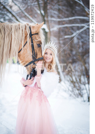 Princess in crown with horse in winter. Fairy tale, snowy queen 119972419