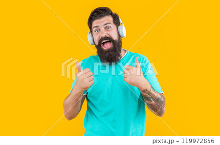 surprised dj guy in music headphones isolated on yellow background. dj guy wearing music headphones 119972856