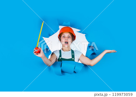 pure contractor. kid wear helmet on construction site. teen girl builder with building tool tape measure. child on repairing work. concept of renovation in workshop. busy professional carpenter pure contractor. kid wear helmet on construction site. teen girl builder with building tool tape measure. child on repairing work. concept of renovation in workshop. busy professional carpenter 119973059