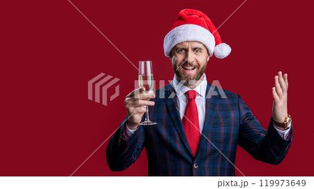 smiling new year businessman in santa hat celebrating. businessman celebrating holiday. 119973649