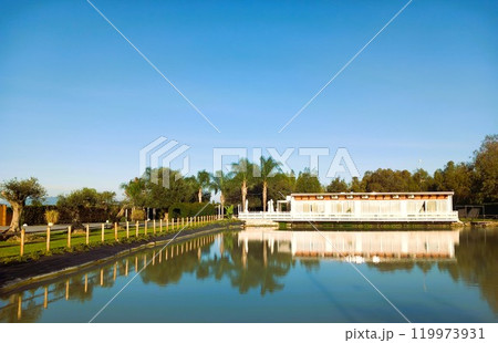 White gazebo on a lake in the park White gazebo on a lake in the park 119973931