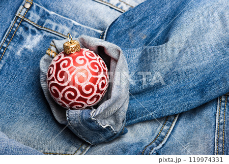 Decorate christmas tree traditional toy. Modern generation celebrate new year and christmas. Celebrate christmas. Ball decoration for christmas tree on denim pants background. Winter holiday concept Decorate christmas tree traditional toy. Modern generation celebrate new year and christmas. Celebrate christmas. Ball decoration for christmas tree on denim pants background. Winter holiday concept 119974331