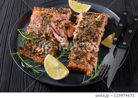 baked salmon fillet with lemon, rosemary on plate 119974672