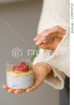 Delicious passion fruit and banana smoothie with raspberries in a glass on your hand Delicious passion fruit and banana smoothie with raspberries in a glass on your hand 119974719