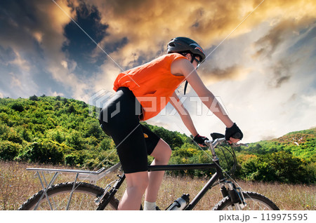 Biker in the mountains at sunset Biker in the mountains at sunset 119975595