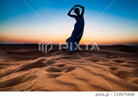 silhouette young woman in sandy desert at sunset 119975606