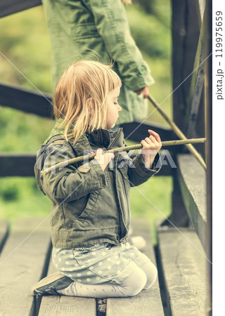 fisher girl carefully looking after the fishing rod 119975659