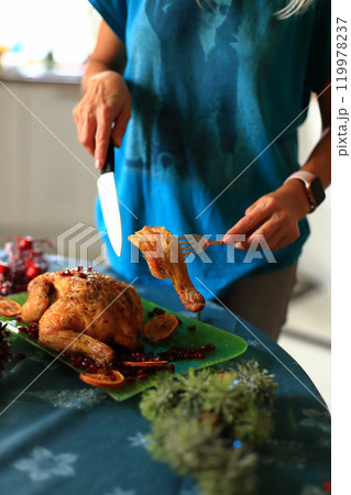 carving a beautifully roasted turkey, a centerpiece of the Christmas feast. This moment reflects the cherished traditions of holiday cooking and the warmth of family celebrations carving a beautifully roasted turkey, a centerpiece of the Christmas feast. This moment reflects the cherished traditions of holiday cooking and the warmth of family celebrations 119978237