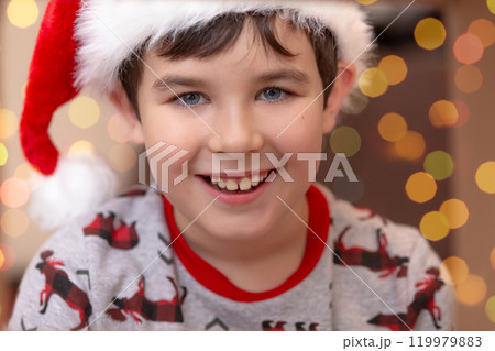 Portrait of a handsome smiling European boy in a red cap 119979883