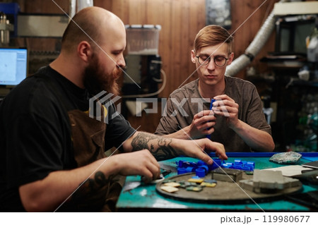 Men sorting supplies before processing 119980677
