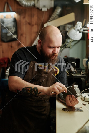 Young factory worker using caliper 119980719