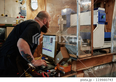 Male engineer operating cutting machine 119980743