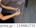 A close-up shot of hands gripping a game controller, showcasing the excitement and intensity of gaming. 119981735