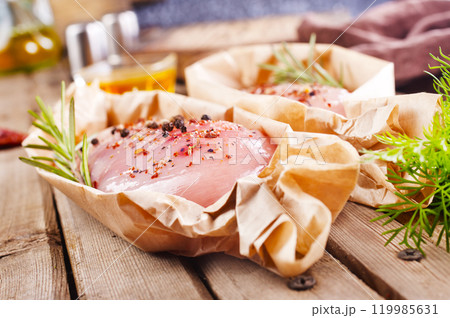 Fresh chicken breast fillet on a wooden table Fresh chicken breast fillet on a wooden table 119985631