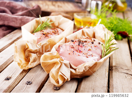 Fresh chicken breast fillet on a wooden table Fresh chicken breast fillet on a wooden table 119985632