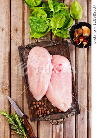 Fresh chicken breast fillet on a wooden table 119985637