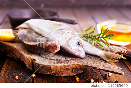 raw fish on wooden board raw fish on wooden board 119985649