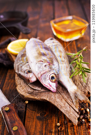 raw fish on wooden board raw fish on wooden board 119985650