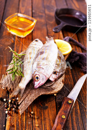 raw fish on wooden board raw fish on wooden board 119985651